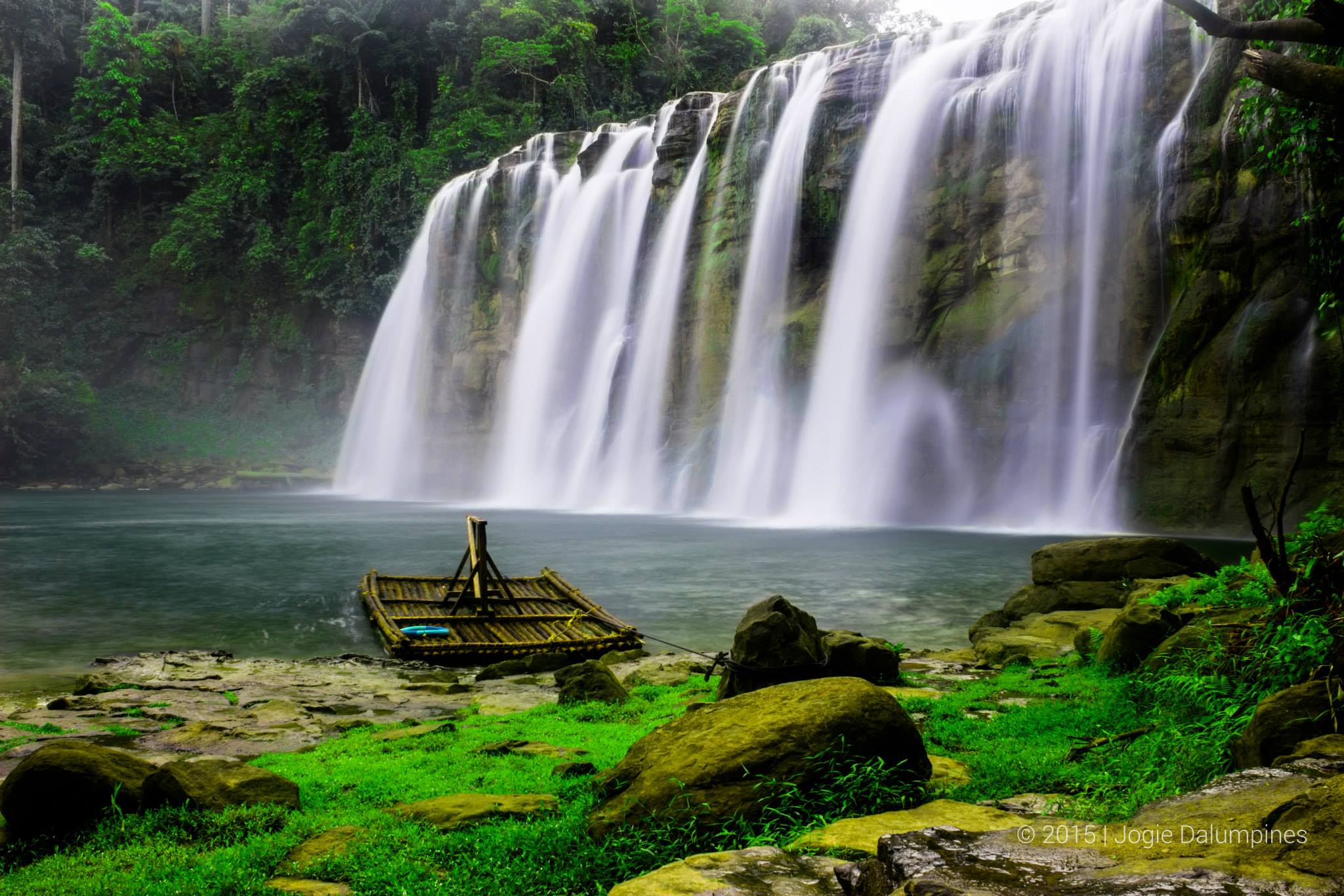 <b class="font-bara"><i class="bi bi-geo-fill h4"></i> TINUY-AN FALLS</b> <br/>Tinuy-an Falls is a multi-tiered waterfall in Bislig, Surigao del Sur in the southern island of Mindanao, Philippines. Bislig is a city known as the Booming City by the Bay. The waterfall itself has been featured in various international travel magazines and TV shows.

The Tinuy-an falls are 95 m wide and 55 metres (180 ft) high, touted as the little Niagara Falls of the Philippines. Tinuy-an is a white water curtain that flows in three levels (with a fourth tier hidden from view) and is said to be the widest waterfall in the Philippines. Every morning, the area shows a rainbow between 9 a.m. to 11 a.m. One may also ride a raft to get close to its cascades and get a water “massage.”

Tinuy-an Falls is a co-management effort between the tourism office of Bislig and the Manobo Tribal Council.